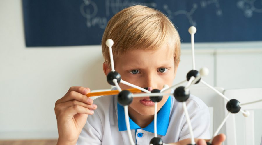 Curious kid counting atoms in molecular model